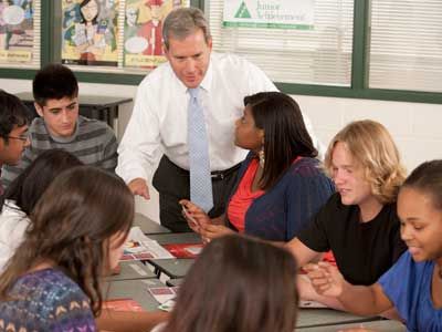 A volunteer assisting students in a lesson